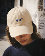 Chica con gorra Core beis y jersey oscuro